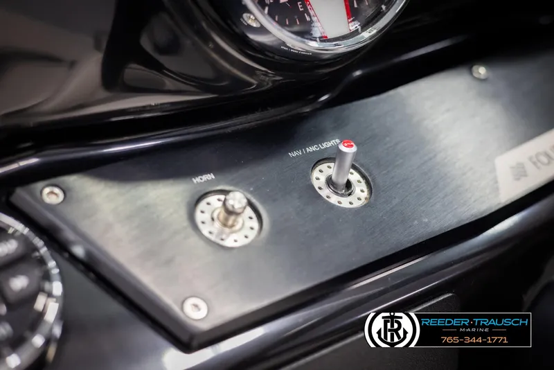Slide: The Image of Dashboard controls of 2019 Four Winns HD200 boat, featuring horn and navigation lights switches. - 31