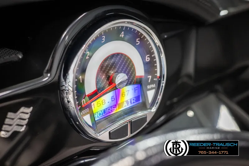 Slide: The Image of Close-up of 2019 Four Winns HD200 boat dashboard gauge displaying RPM and air temperature. - 33