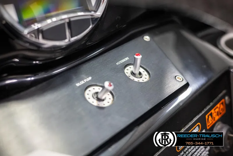 Slide: The Image of Control panel of a 2019 Four Winns HD200 boat with switches and gauge. - 35