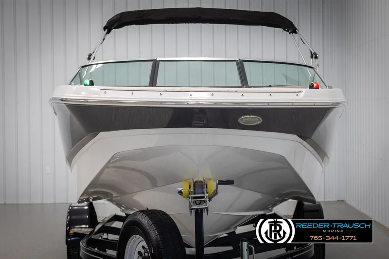 Slide: The Image of 2019 Four Winns HD200 boat on trailer, front view in showroom. - 8