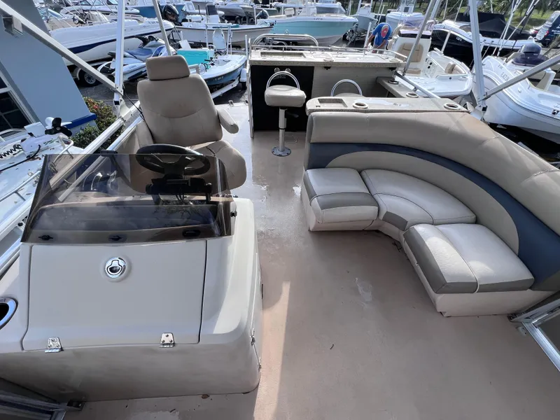 Slide: The Image of 2013 Harris FloteBote Sunliner 220 pontoon boat interior with seating and helm. - 11