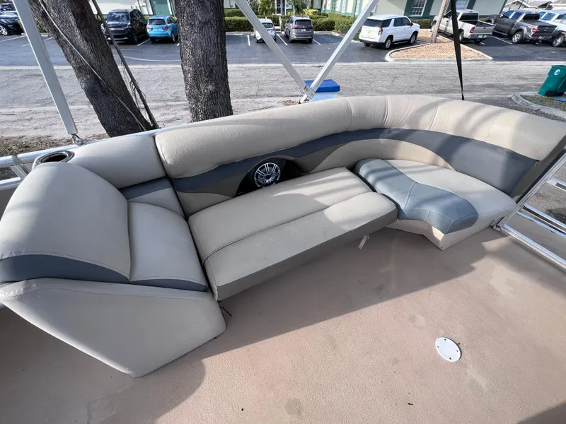 Slide: The Image of 2013 Harris FloteBote Sunliner 220 pontoon boat interior with beige and gray seating. - 12