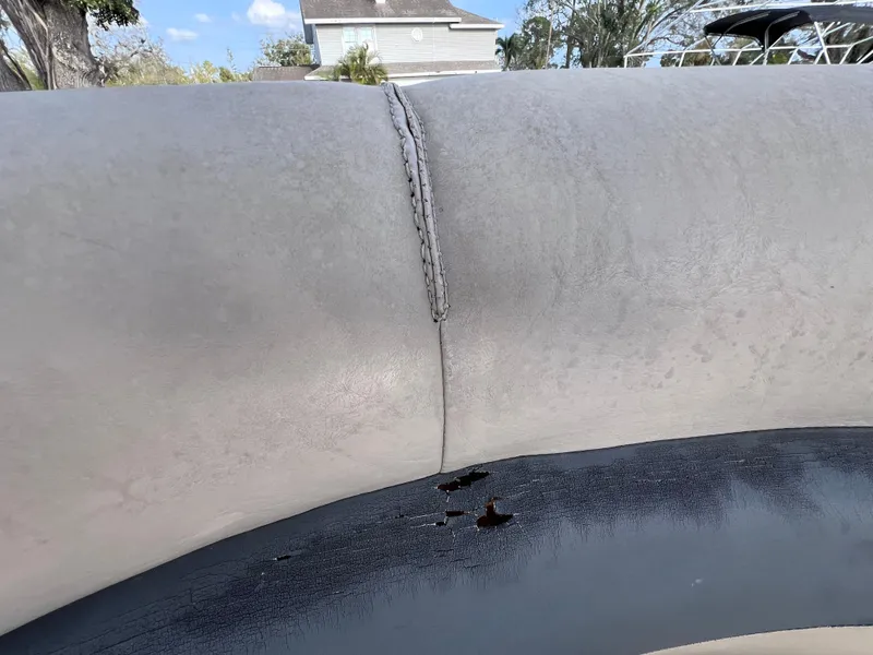 Slide: The Image of 2013 Harris FloteBote Sunliner 220 with damaged upholstery and visible wear. - 14