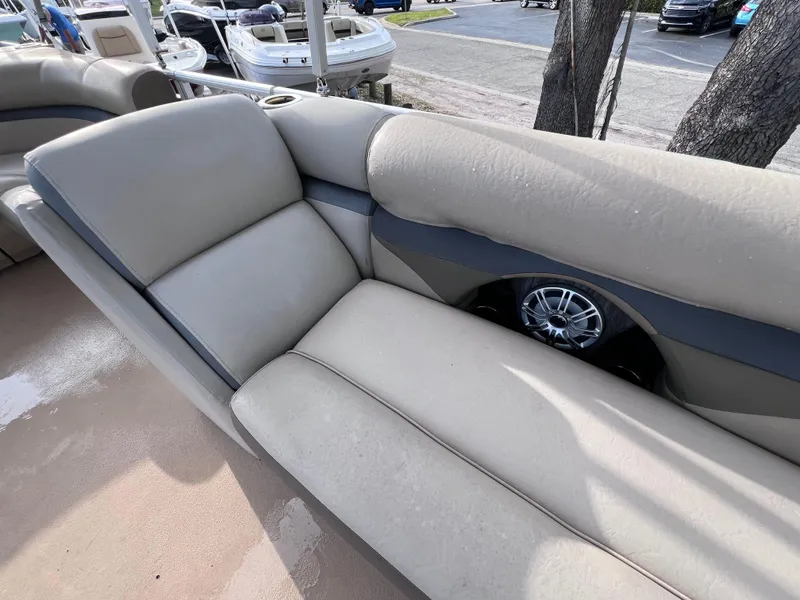 Slide: The Image of 2013 Harris FloteBote Sunliner 220 interior seating with cup holder and speaker. - 16