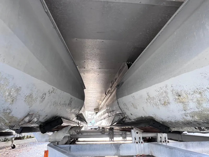 Slide: The Image of Underneath view of a 2013 Harris FloteBote Sunliner 220 pontoon boat on a trailer. - 27