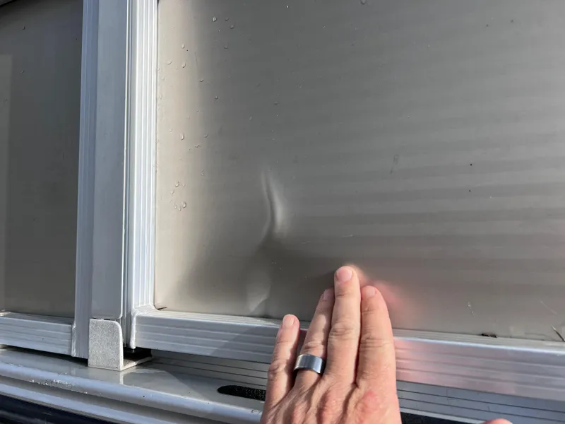 Slide: The Image of Hand touching dented panel on 2013 Harris FloteBote Sunliner 220. - 3