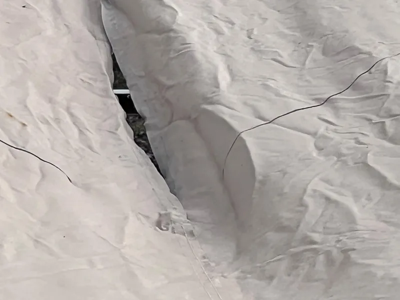 Slide: The Image of Torn cover on 2013 Harris FloteBote Sunliner 220 boat, revealing underlying structure. - 32