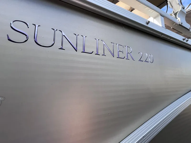 Slide: The Image of 2013 Harris FloteBote Sunliner 220 boat side view with model name. - 7