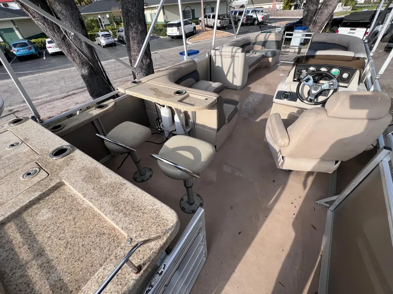 Slide: The Image of 2013 Harris FloteBote Sunliner 220 interior with seating and steering console. - 9