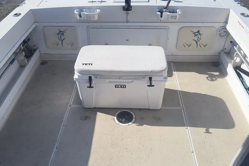 Slide: The Image of 1988 Grady-White 255 Sailfish Walkaround deck with Yeti cooler, featuring marlin graphics. - 7