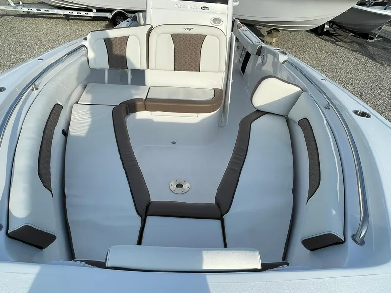 Slide: The Image of 2025 Tidewater 232 SS boat interior with cushioned seating and sleek design. - 10