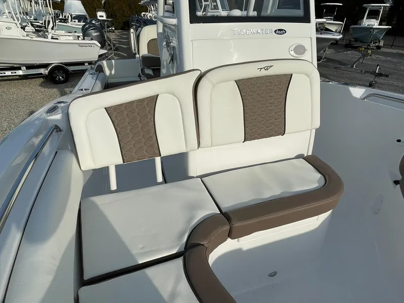Slide: The Image of 2025 Tidewater 232 SS boat interior with cushioned seating and modern design. - 11