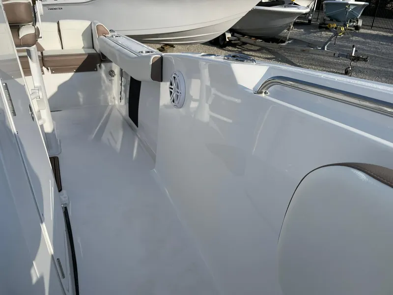 Slide: The Image of 2025 Tidewater 232 SS boat interior with white seating and speaker. - 16