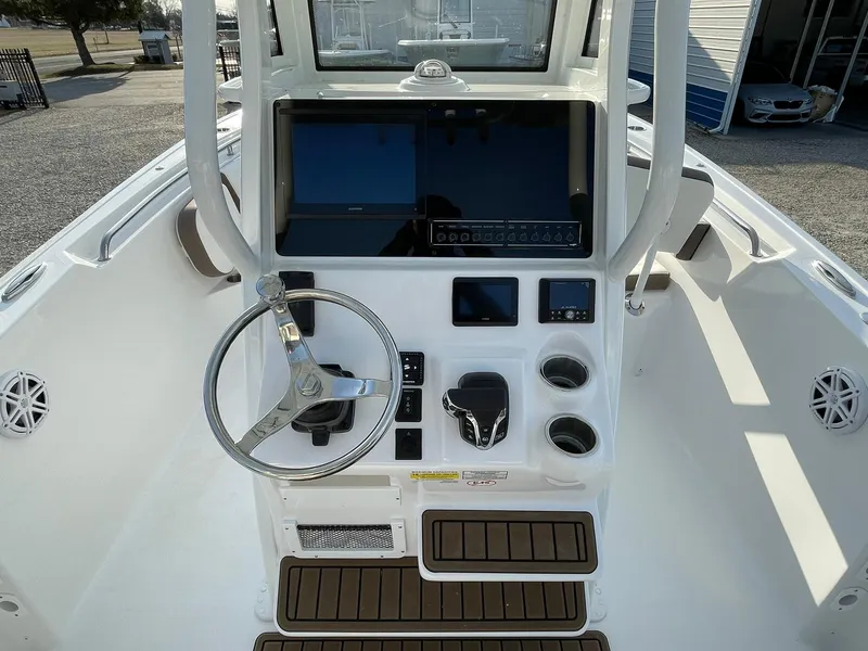 Slide: The Image of 2025 Tidewater 232 SS boat interior with modern helm and steering wheel. - 23