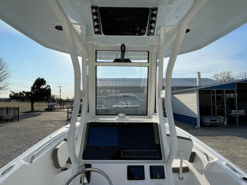 Slide: The Image of 2025 Tidewater 232 SS boat console with steering wheel and electronic controls. - 24
