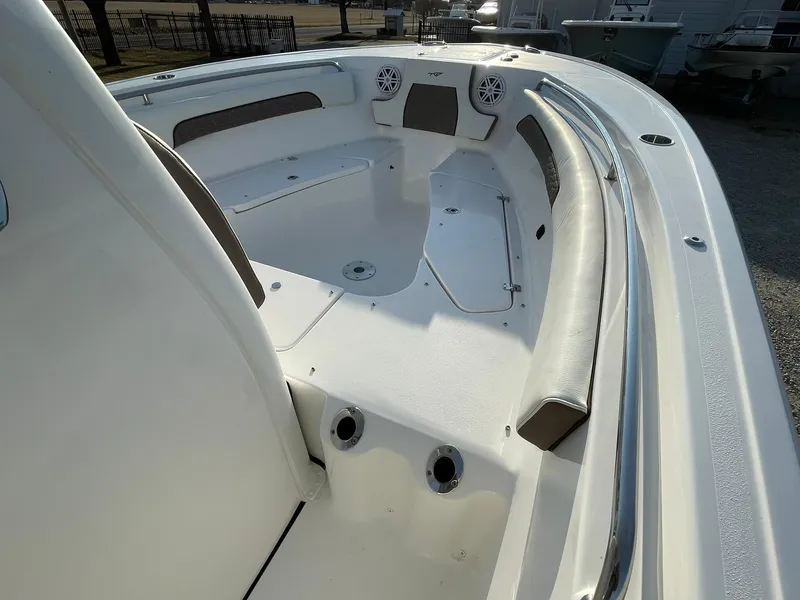 Slide: The Image of 2025 Tidewater 232 SS boat interior with modern helm and seating under bright sun. - 32