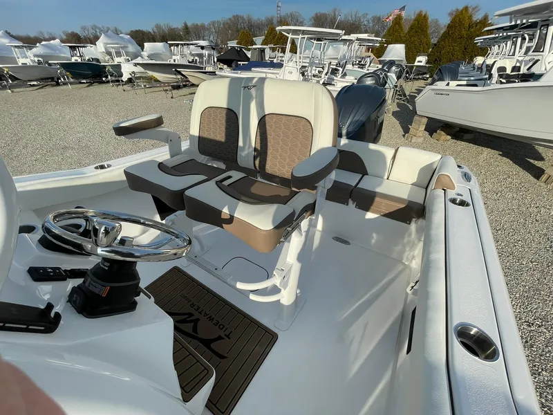 Slide: The Image of 2025 Tidewater 232 SS boat seating with brown and white upholstery. - 36
