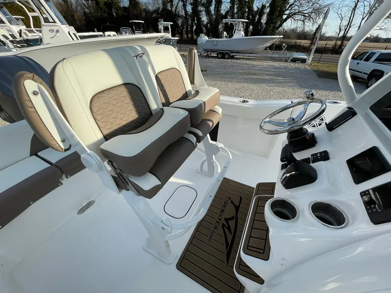 Slide: The Image of 2025 Tidewater 232 SS boat interior with dual seats and steering console. - 38