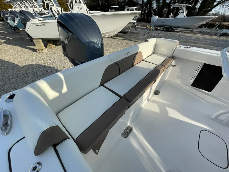 Slide: The Image of 2025 Tidewater 232 SS boat interior with cushioned seating and rod holders. - 40