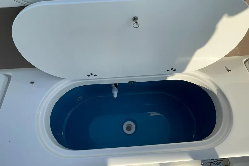 Slide: The Image of 2025 Tidewater 232 SS boat interior with seating and storage compartments. - 42