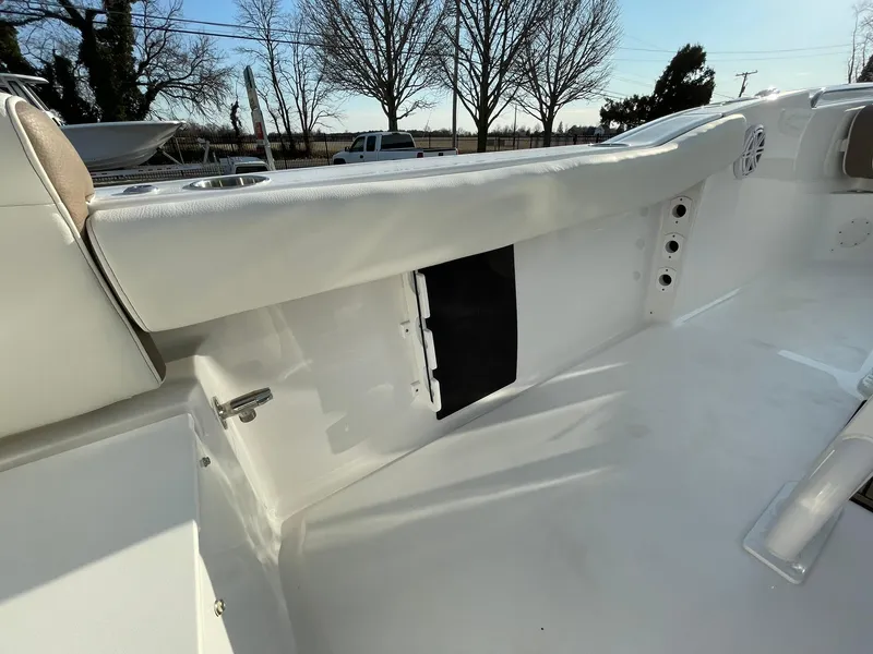 Slide: The Image of Open storage compartment on 2025 Tidewater 232 SS boat, featuring a blue interior. - 43