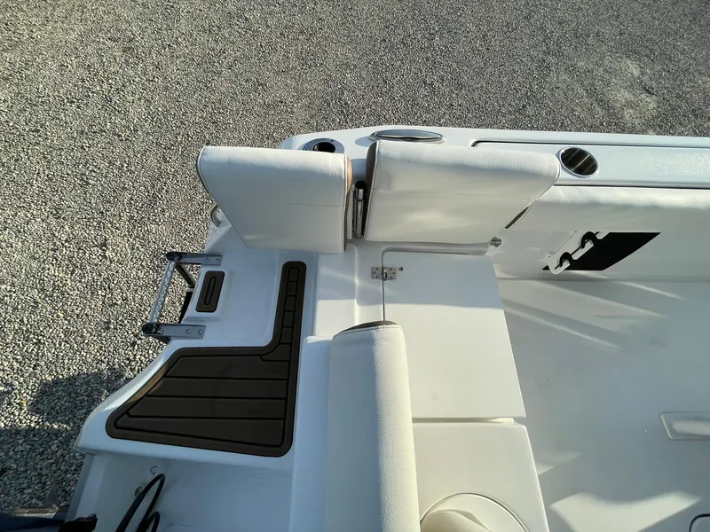Slide: The Image of 2025 Tidewater 232 SS boat interior with cushioned seating and storage compartments. - 47
