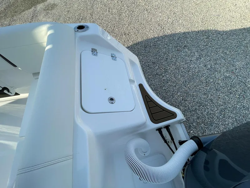 Slide: The Image of 2025 Tidewater 232 SS boat interior with white seating and deck details. - 48