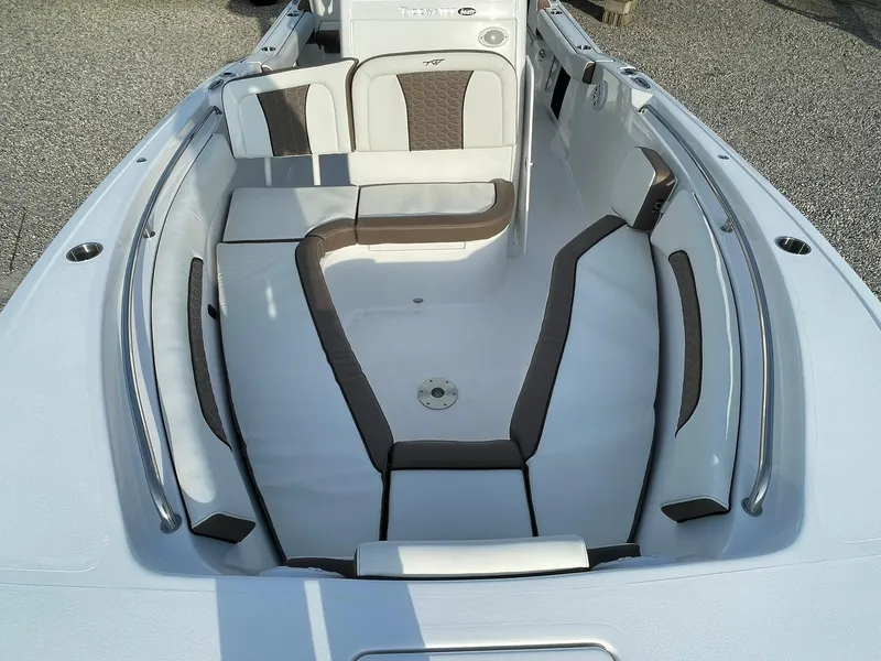 Slide: The Image of 2025 Tidewater 232 SS boat interior with cushioned seating and sleek design. - 9