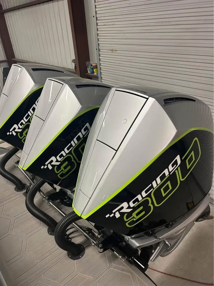 Slide: The Image of 2024 Statement 350 Open boat engines, Racing 300 model, in a garage setting. - 13