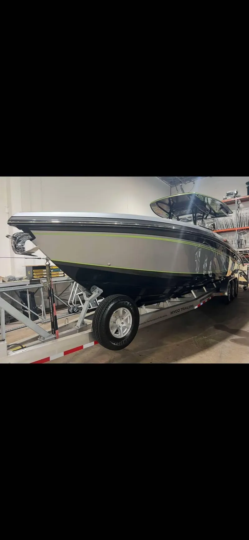 Slide: The Image of 2024 Statement 350 Open boat on trailer in indoor storage. - 14