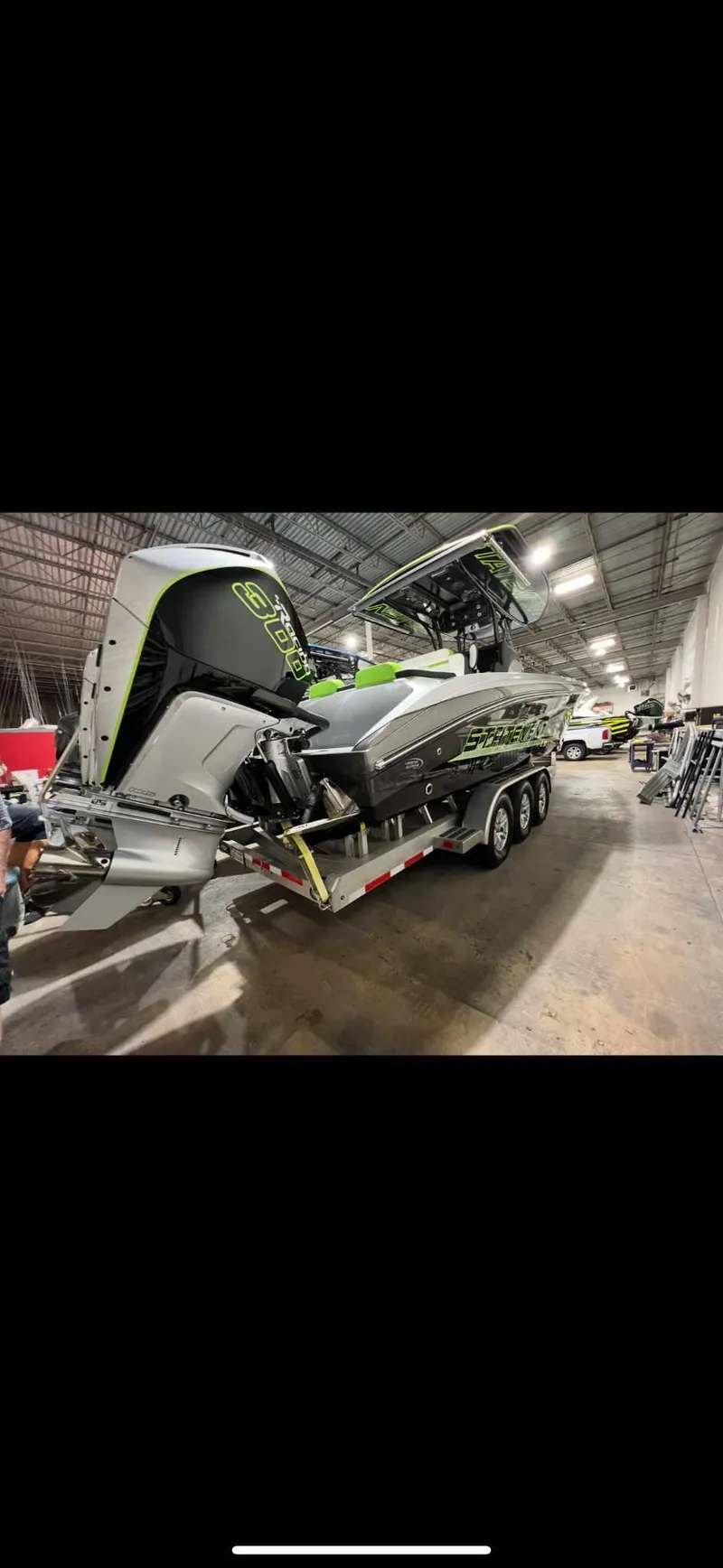 Slide: The Image of 2024 Statement 350 Open boat in a warehouse, showcasing sleek design and powerful engines. - 15