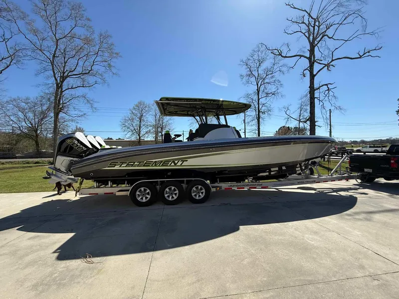 Slide: The Image of 2024 Statement 350 Open boat on trailer, parked outdoors under clear blue sky. - 19