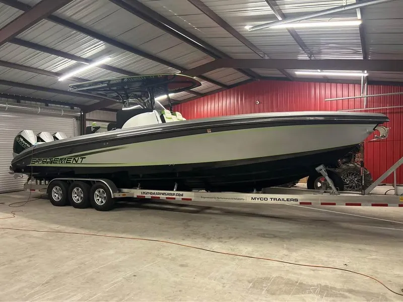 Slide: The Image of 2024 Statement 350 Open boat on trailer in a warehouse setting. - 25