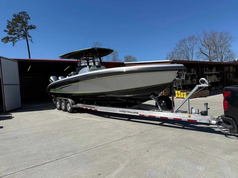 Slide: The Image of 2024 Statement 350 Open boat on trailer, parked outdoors near a building. - 3