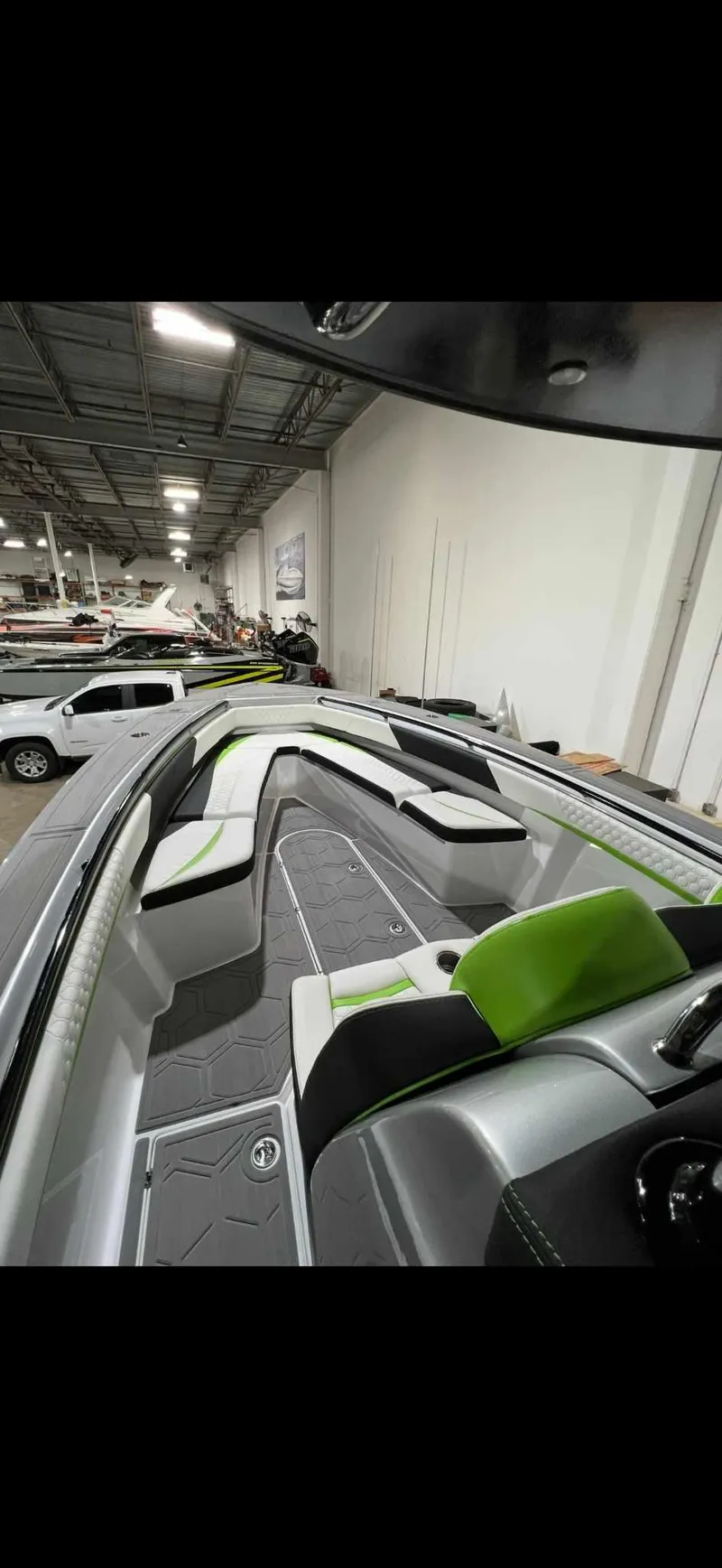 Slide: The Image of 2024 Statement 350 Open boat interior with modern seating and sleek design in a showroom. - 30