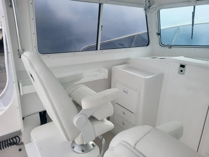 Slide: The Image of Interior of 2025 Steiger Craft 28 Fisherman boat with white seating and storage. - 10