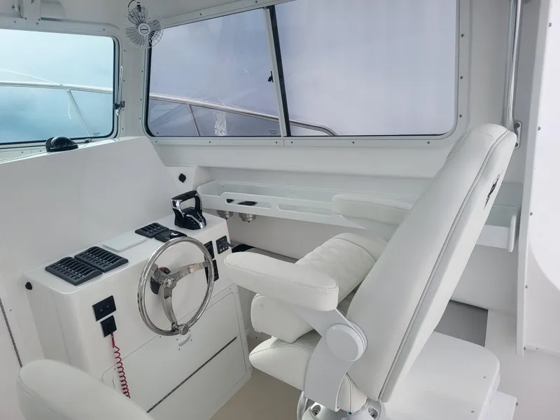 Slide: The Image of 2025 Steiger Craft 28 Fisherman helm with modern controls and comfortable seating. - 11
