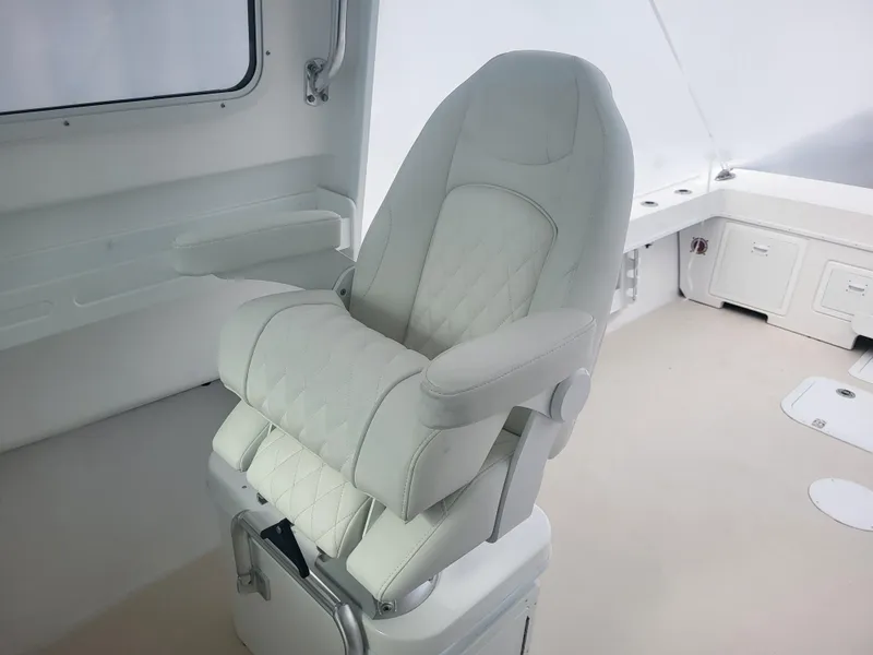 Slide: The Image of Luxury captain's chair on 2025 Steiger Craft 28 Fisherman boat, featuring elegant white upholstery. - 12