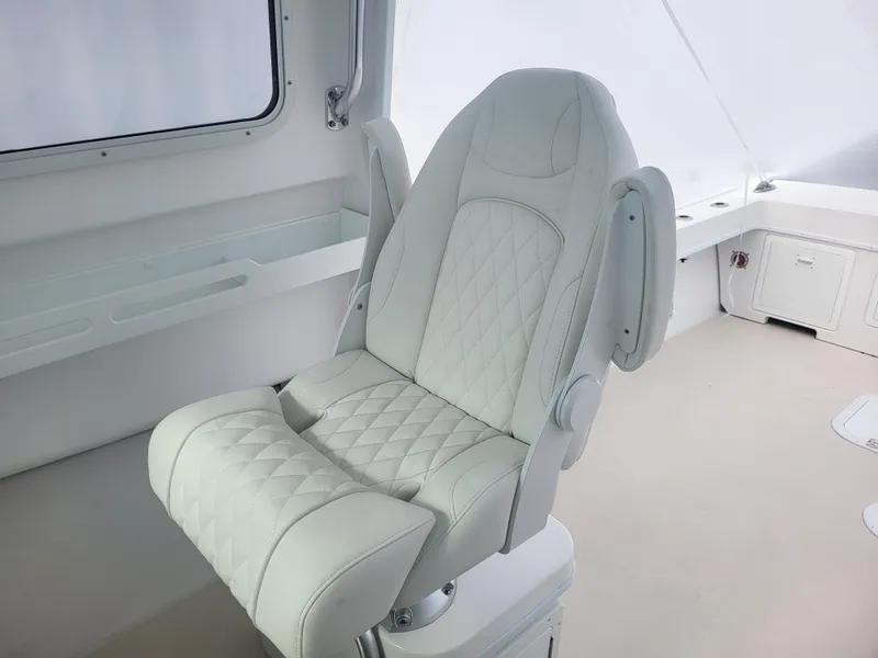 Slide: The Image of Luxury seating on 2025 Steiger Craft 28 Fisherman boat, featuring white quilted upholstery. - 14