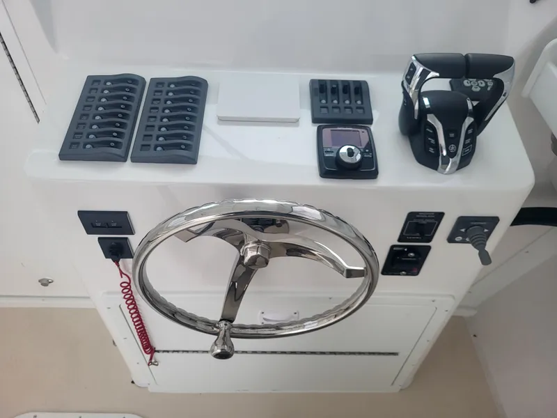 Slide: The Image of Steiger Craft 28 Fisherman 2025 helm with steering wheel and control panel. - 16