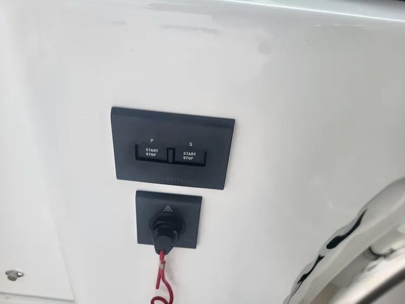 Slide: The Image of Control panel on 2025 Steiger Craft 28 Fisherman boat, featuring start/stop buttons. - 21