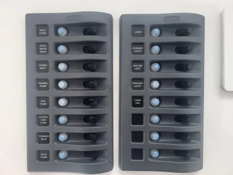 Slide: The Image of Control panel of 2025 Steiger Craft 28 Fisherman boat with labeled switches. - 22