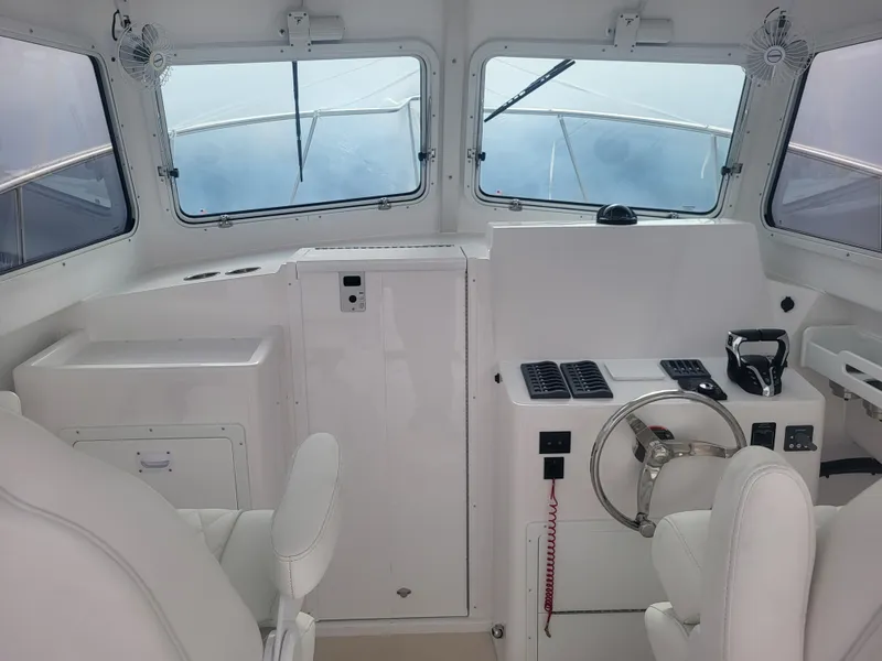 Slide: The Image of 2025 Steiger Craft 28 Fisherman boat interior with helm, steering wheel, and seating. - 25