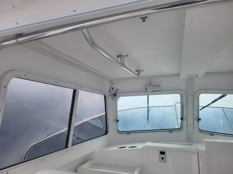 Slide: The Image of 2025 Steiger Craft 28 Fisherman interior cabin with windows and seating. - 27