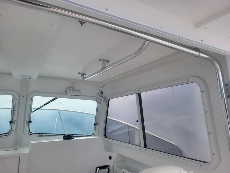 Slide: The Image of Interior view of 2025 Steiger Craft 28 Fisherman boat cabin with windows. - 28