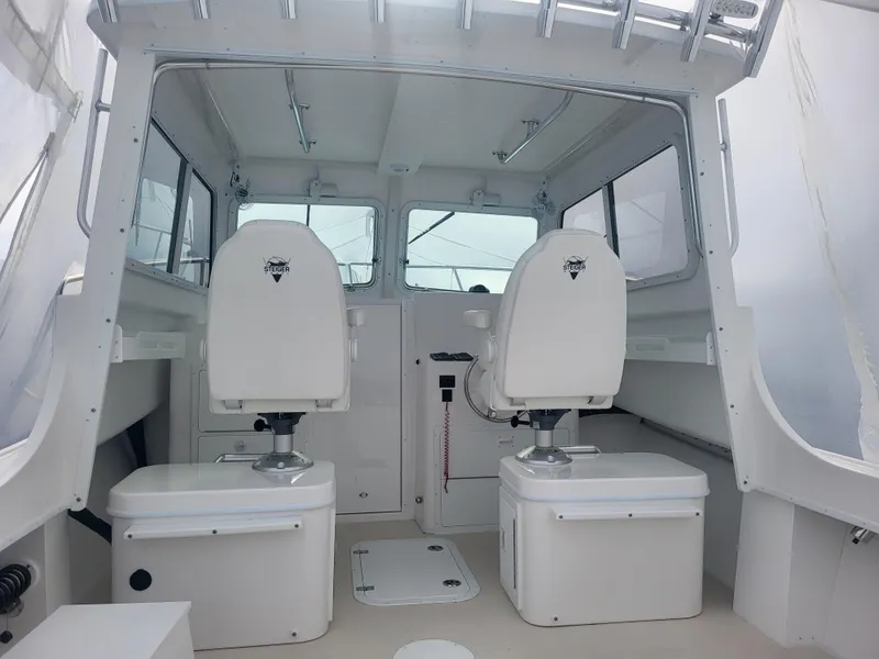 Slide: The Image of 2025 Steiger Craft 28 Fisherman boat interior with two white captain chairs. - 4