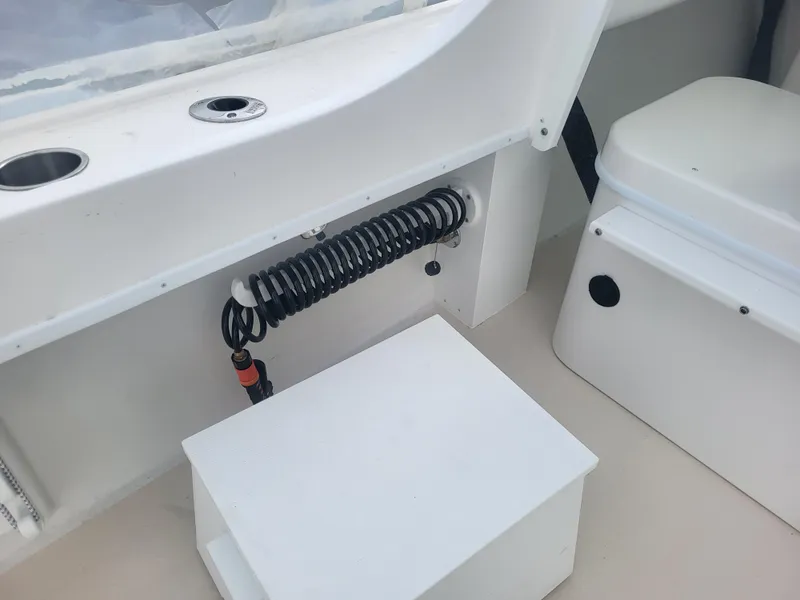 Slide: The Image of Interior of 2025 Steiger Craft 28 Fisherman boat, featuring seating and coiled hose. - 5