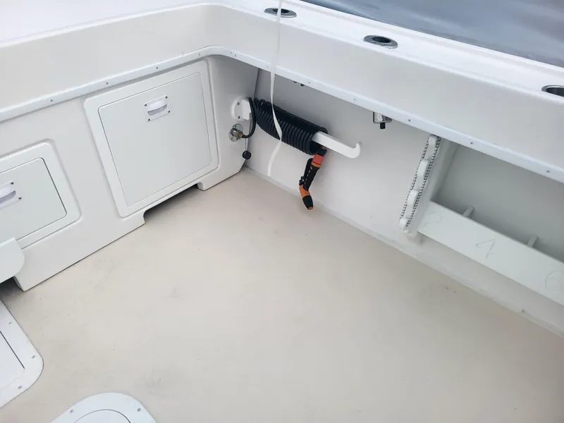 Slide: The Image of 2025 Steiger Craft 28 Fisherman boat interior with storage compartments and fishing equipment. - 6