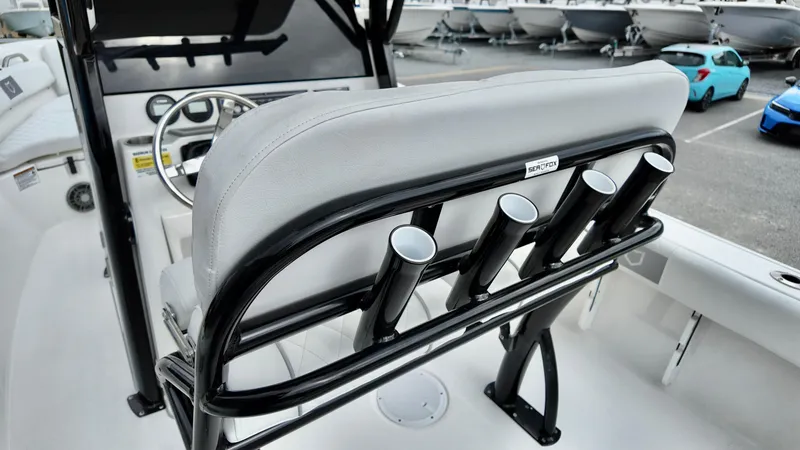 Slide: The Image of 2025 Sea Fox 228 Commander boat interior with rod holders and steering wheel. - 20