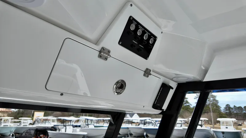 Slide: The Image of 2025 Sea Fox 228 Commander interior console with control panel and storage compartment. - 22